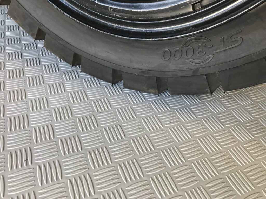 Lamipiso textured industrial flooring under a vehicle wheel